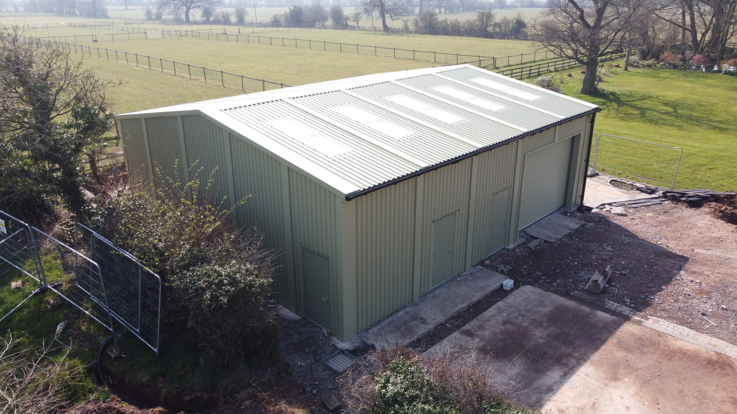 Prefabricated steel storage building with roller shutter and personnel doors installed in Staffordshire by Saredon Steel Buildings Ltd